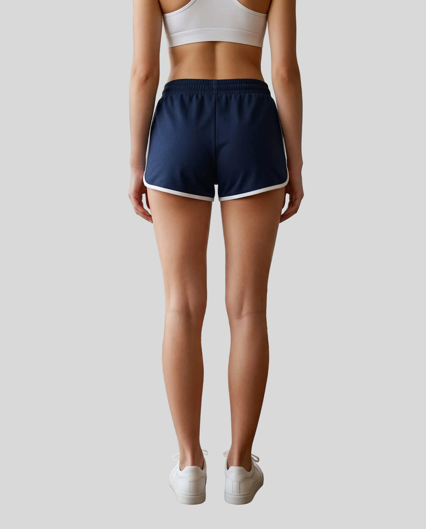 Back view of TrackLine Retro Shorts in Navy Blue with White contrast binding on model