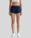 Model wearing TrackLine Retro Shorts in Navy Blue with White contrast binding front view