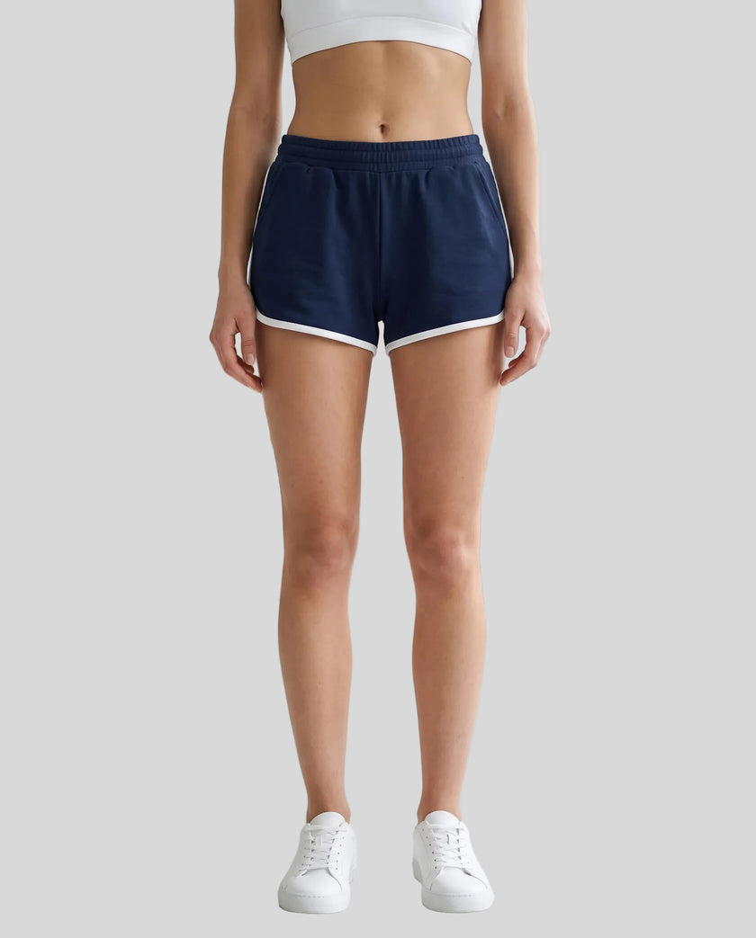 Model wearing TrackLine Retro Shorts in Navy Blue with White contrast binding front view