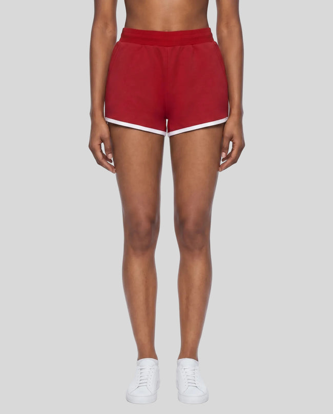 Model wearing TrackLine Retro Shorts in Red with White contrast binding front view