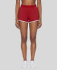 Model wearing TrackLine Retro Shorts in Red with White contrast binding front view