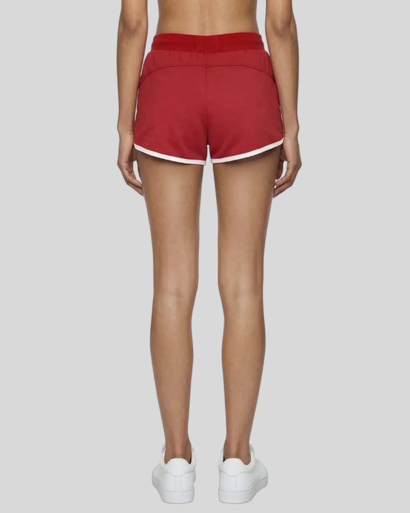 Back view of model wearing the Athlesi TrackLine Retro Shorts in red and white
