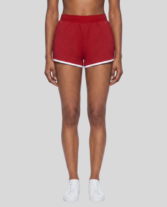 Model wearing the Athlesi TrackLine Retro Shorts in red and white front view