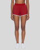 Model wearing the Athlesi TrackLine Retro Shorts in red and white front view