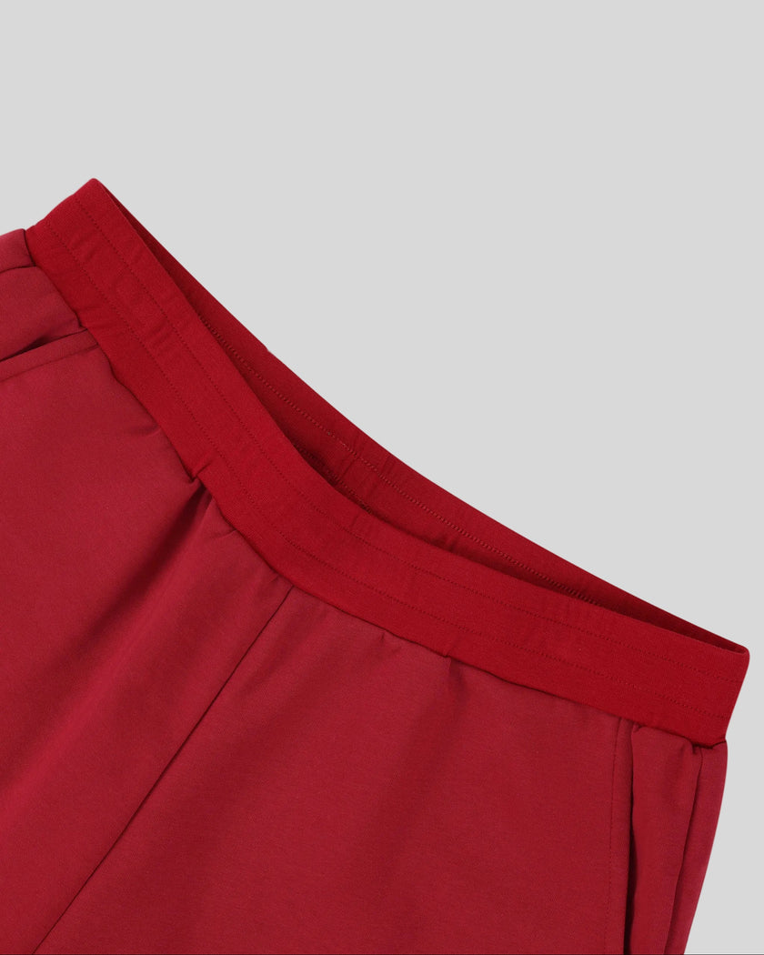 Front elastic waistband detail of the Athlesi TrackLine Retro Shorts in red and white
