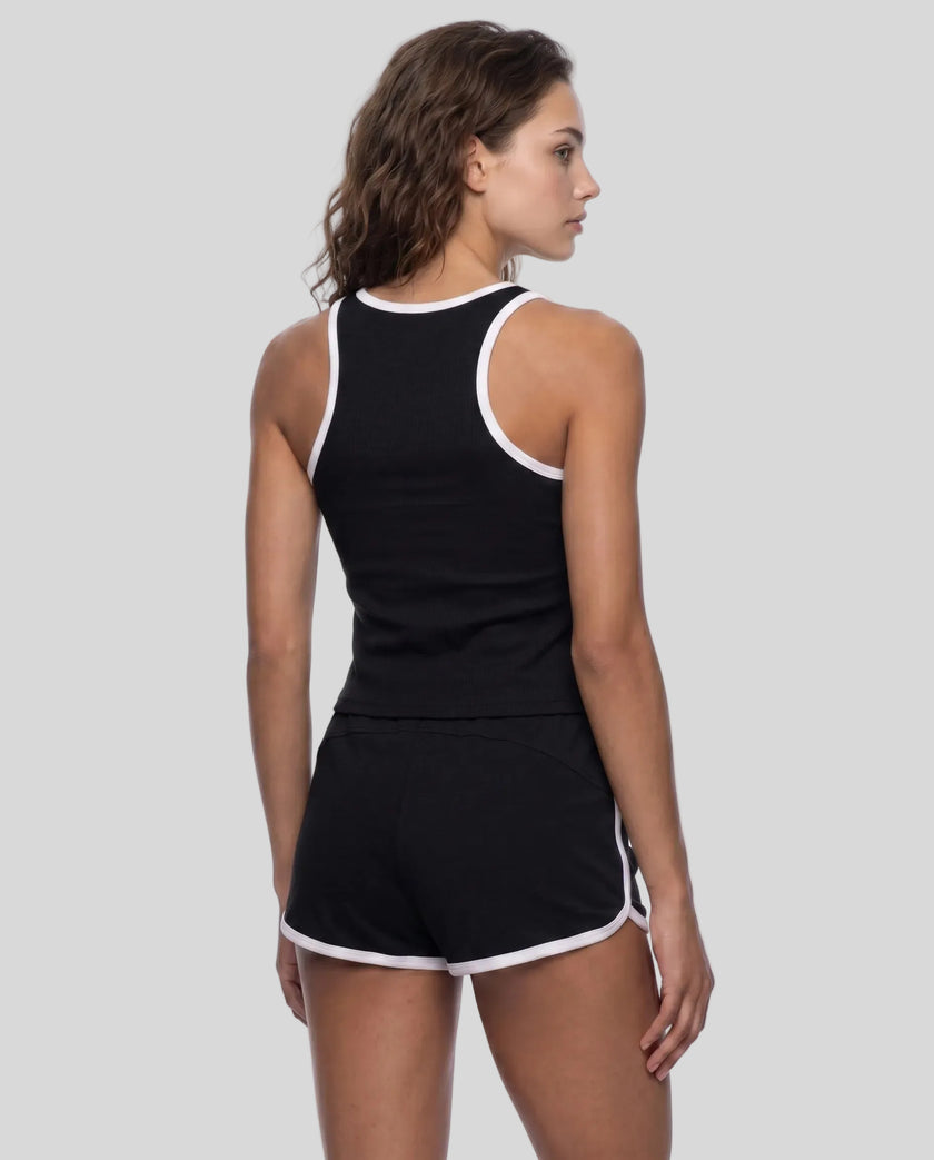 Back view of model wearing the Athlesi TrackLine Retro Tank in black and white with matching retro shorts