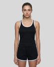 Model wearing the Athlesi TrackLine Retro Tank in black and white front view with matching retro shorts
