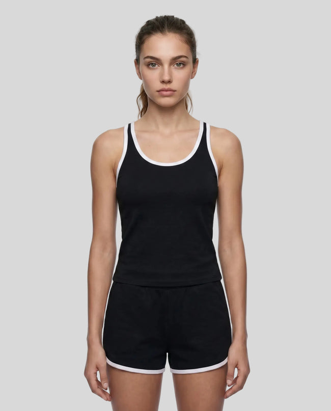 Model wearing the Athlesi TrackLine Retro Tank in black and white front view with matching retro shorts