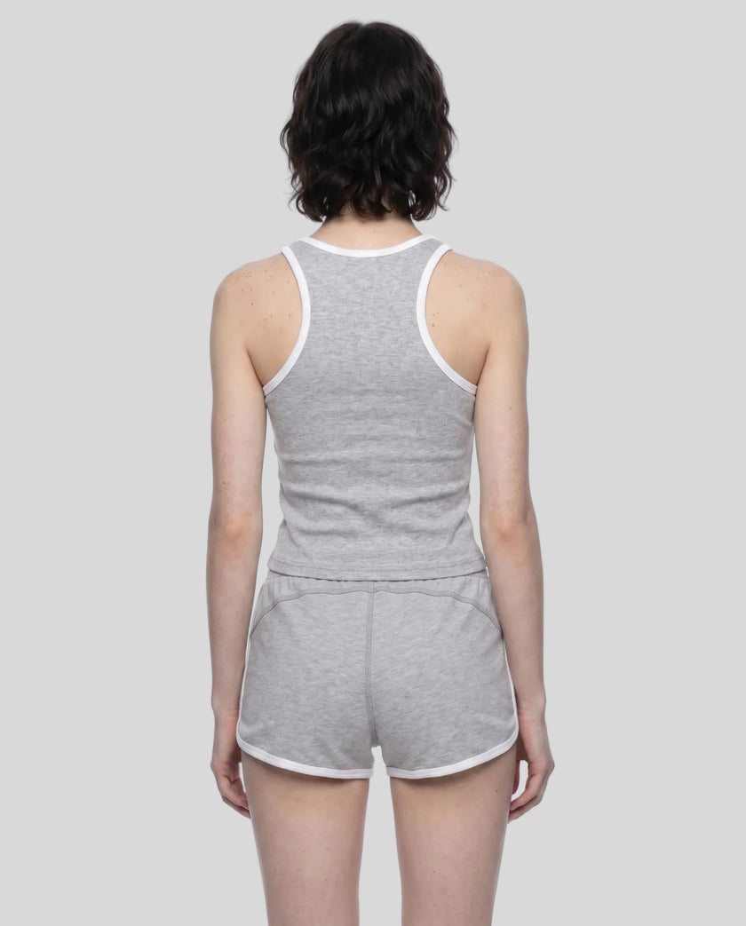 Back view of model wearing the Athlesi TrackLine Retro Tank in flower gray and white with matching retro shorts