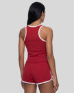 Back view of model wearing the Athlesi TrackLine Retro Tank in red and white with matching retro shorts