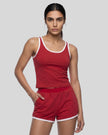 Angled front view of model wearing the Athlesi TrackLine Retro Tank in red and white