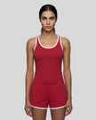 Model wearing the Athlesi TrackLine Retro Tank in red and white front view with matching retro shorts