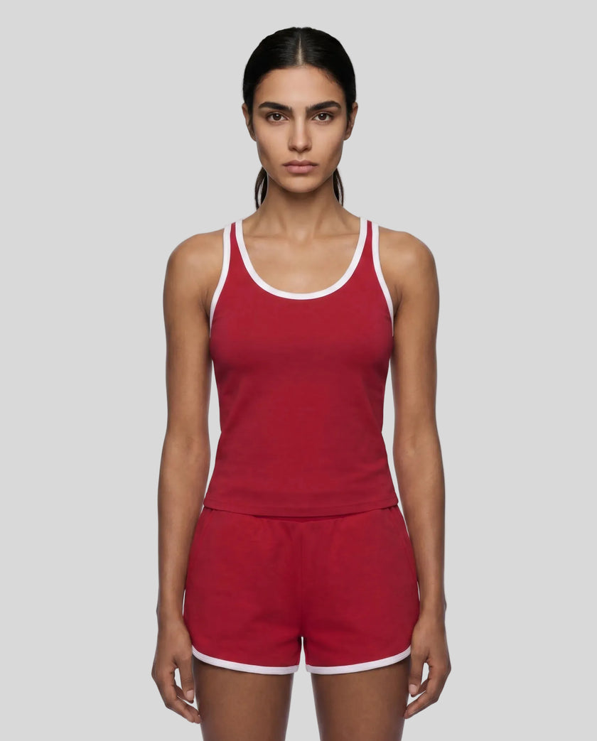 Model wearing the Athlesi TrackLine Retro Tank in red and white front view with matching retro shorts