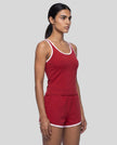 Side angle view of model wearing the Athlesi TrackLine Retro Tank in red and white
