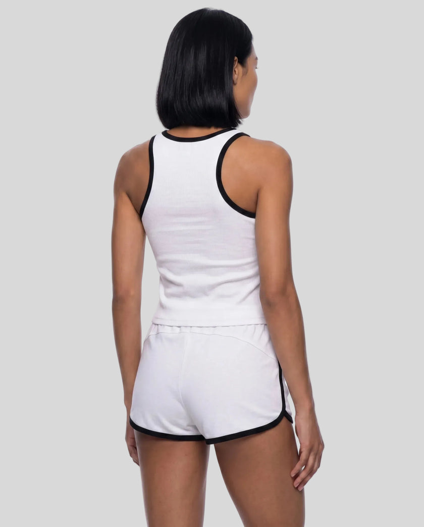 Back view of model wearing the Athlesi TrackLine Retro Tank in white and black with matching retro shorts