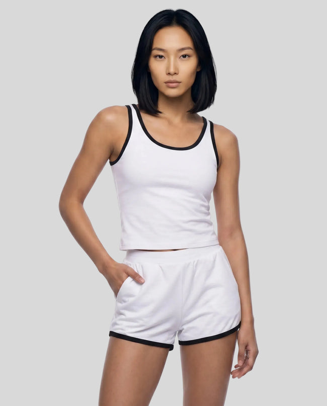 Model wearing the Athlesi TrackLine Retro Tank in white and black front view with matching retro shorts