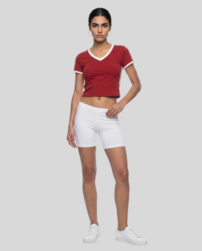 Full body front view of a woman wearing the Athlesi TrackLine Retro V-Neck Tee in red