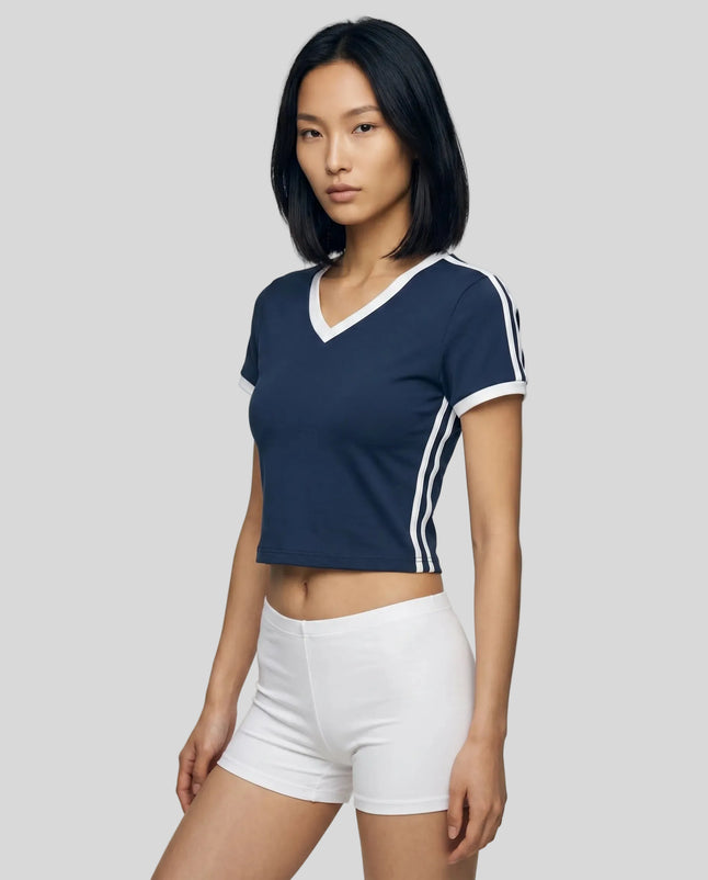 Left angle view of a woman wearing the Athlesi TrackLine Retro V-Neck Tee in blue