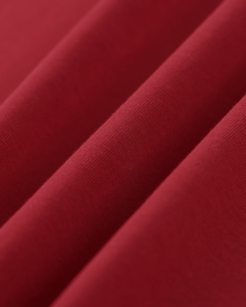 Closeup of the soft stretch cotton fabric on the Athlesi TrackLine Retro V-Neck Tee in red