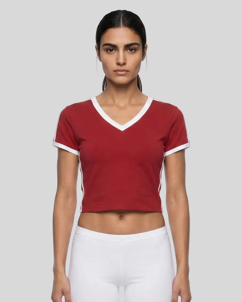 Mid body front view of a woman wearing the Athlesi TrackLine Retro V-Neck Tee in red