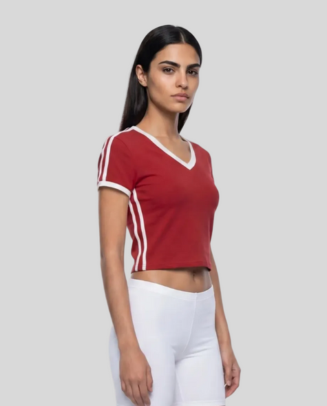 Right angle view of a woman wearing the Athlesi TrackLine Retro V-Neck Tee in red
