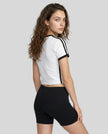 Back view of a woman wearing the Athlesi TrackLine Retro V-Neck Tee in white