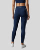 Rear view of a model wearing Trackline Riviera Leggings leg hem closeup in Navy Blue