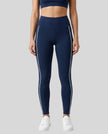 Front view of a model wearing Trackline Riviera Leggings leg hem closeup in Navy Blue