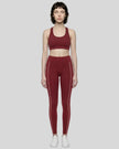 Front view of a model wearing Trackline Riviera Leggings leg hem closeup in Wine Red