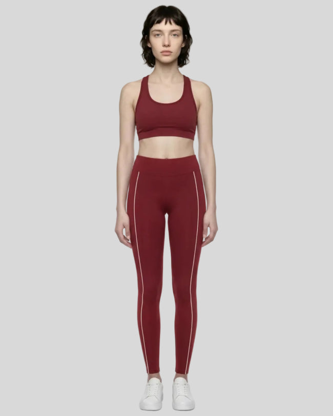Front view of a model wearing Trackline Riviera Leggings leg hem closeup in Wine Red