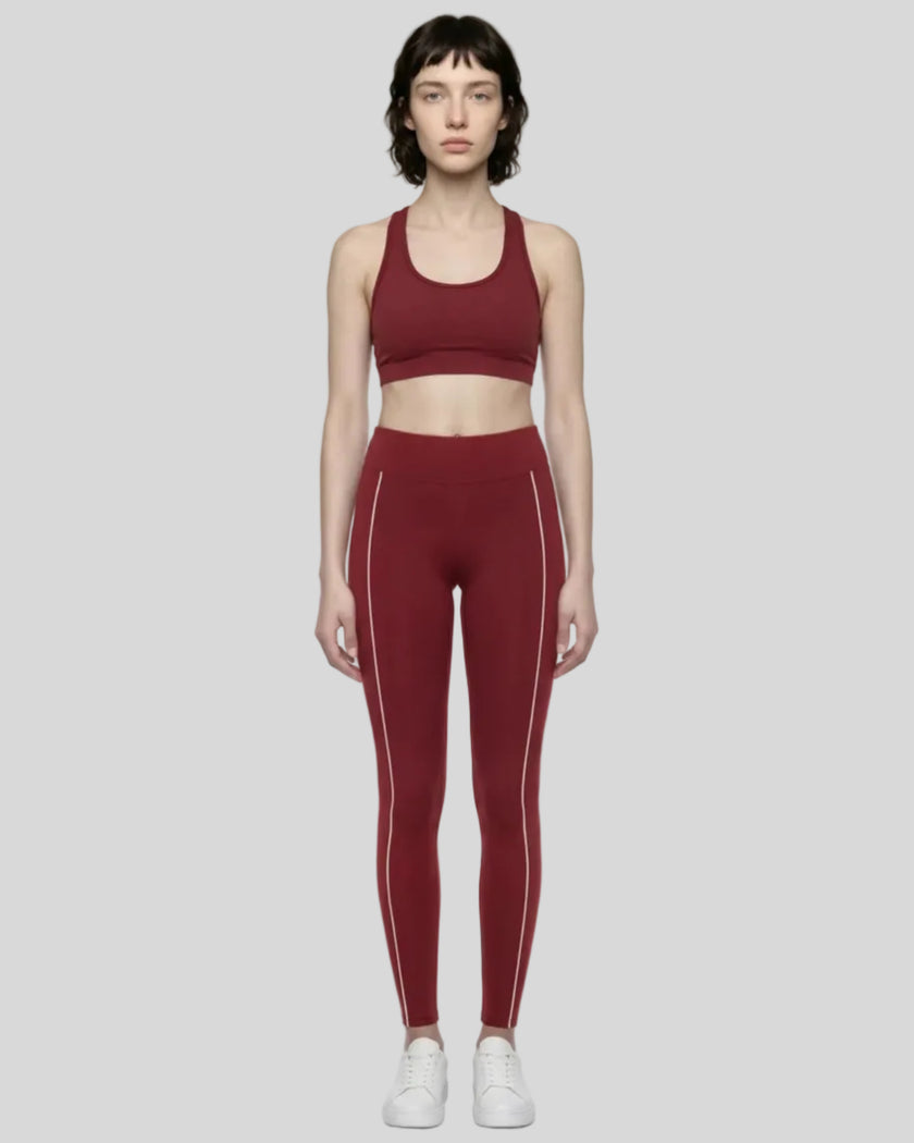 Front view of a model wearing Trackline Riviera Leggings leg hem closeup in Wine Red