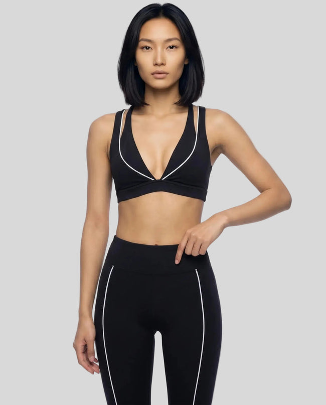 Front view of a woman modeling the Trackline Riviera Sports Bra in Black