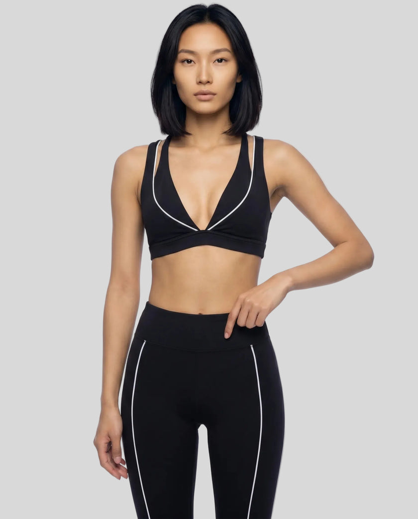Model wearing the TrackLine Riviera Sports Bra in black front view