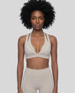 Front view of a woman modeling the Trackline Riviera Sports Bra in Light Apricot