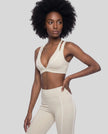 Angled front view of the TrackLine Riviera Sports Bra in light apricot