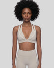Model wearing the TrackLine Riviera Sports Bra in light apricot front view