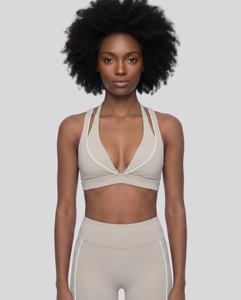 Model wearing the TrackLine Riviera Sports Bra in light apricot front view