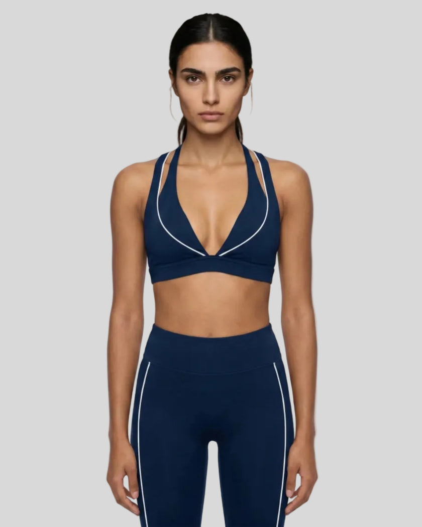 Front view of a woman modeling the Trackline Riviera Sports Bra in Navy Blue