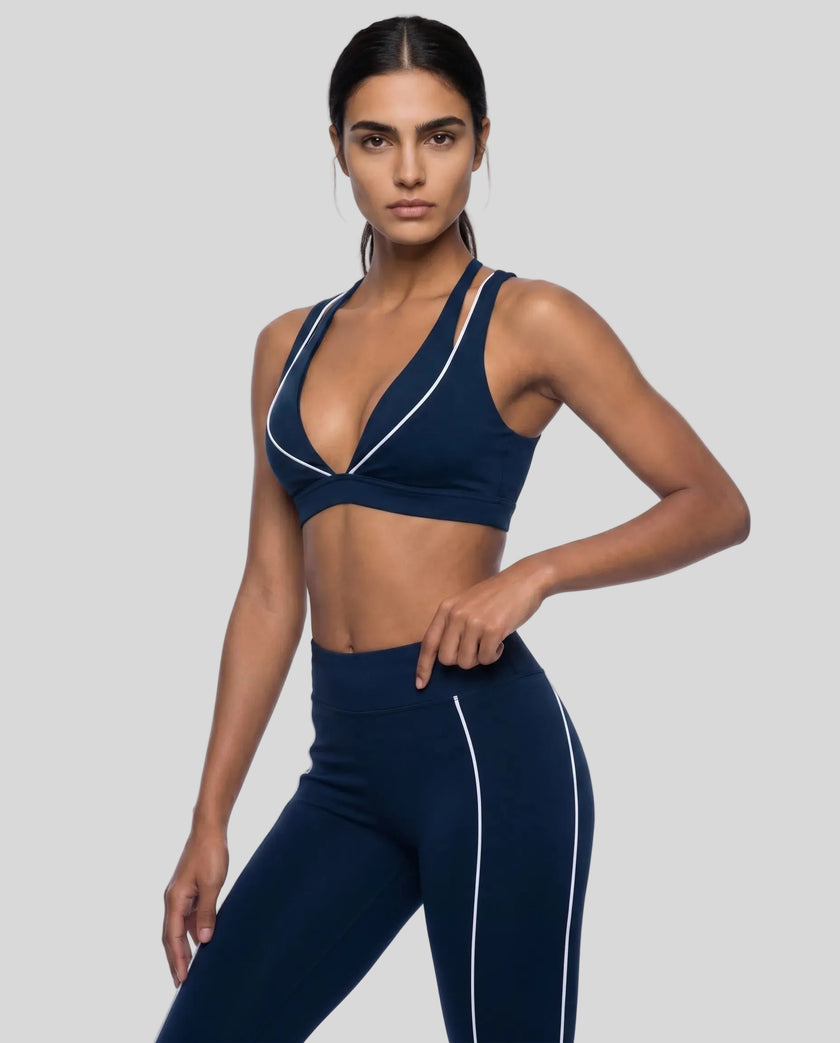 Angled front view of the TrackLine Riviera Sports Bra in navy blue