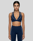 Model wearing the TrackLine Riviera Sports Bra in navy blue front view