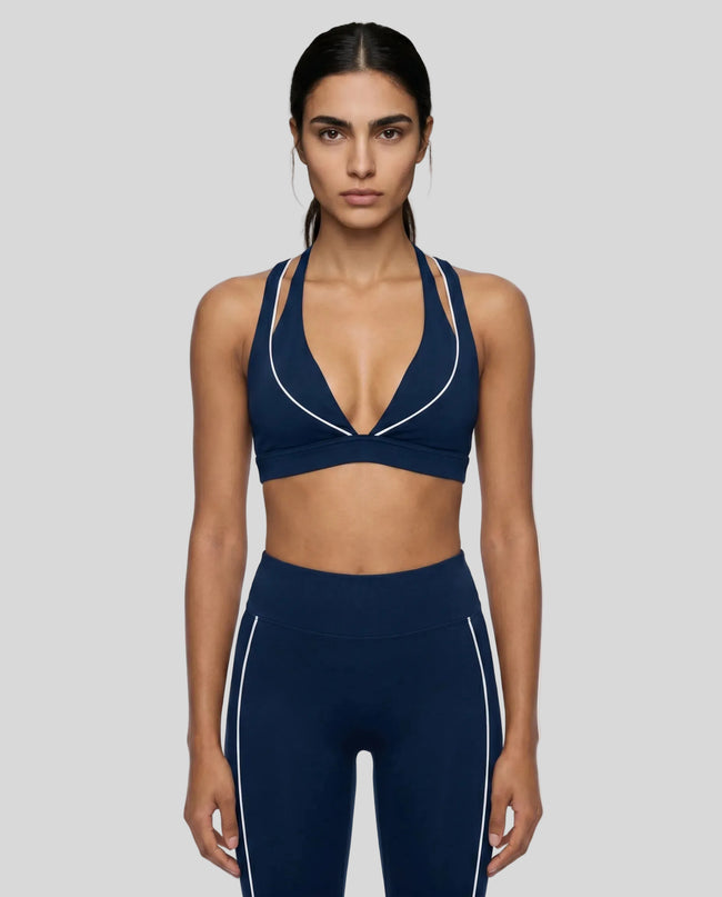 Model wearing the TrackLine Riviera Sports Bra in navy blue front view
