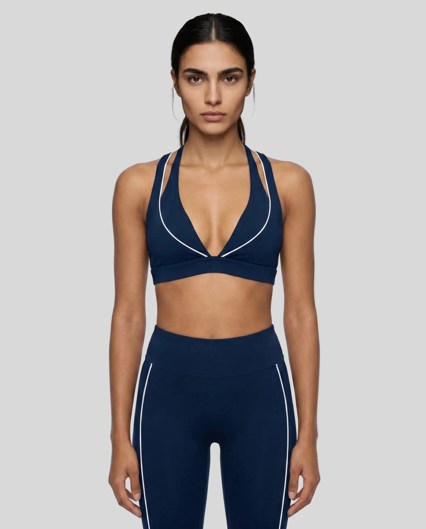 Model wearing the TrackLine Riviera Sports Bra in navy blue front view