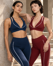 Two women wearing the Trackline Riviera Sports Bra and Leggings in Navy Blue & Wine Red