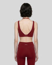 Rear view of a woman modeling the Trackline Riviera Sports Bra in Wine Red