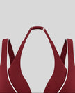 Deep V neckline and contrast piping detail of the TrackLine Riviera Sports Bra