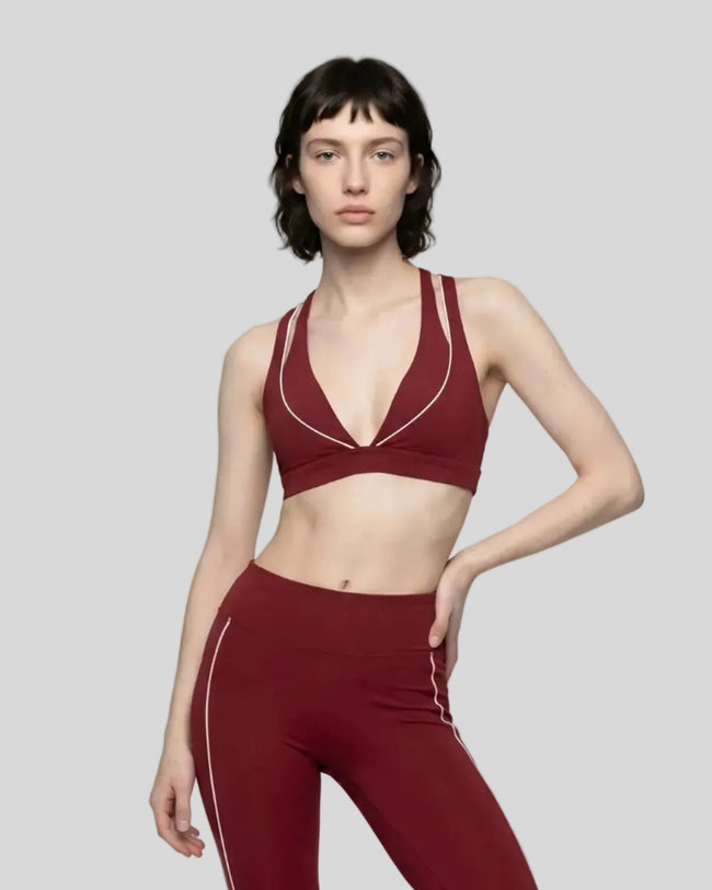 Front view of a woman modeling the Trackline Riviera Sports Bra in Wine Red