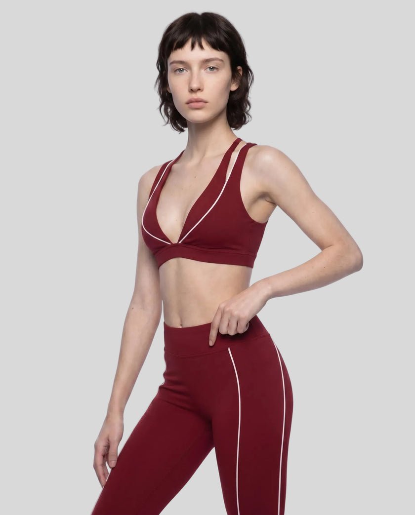 Angled front view of the TrackLine Riviera Sports Bra in wine red