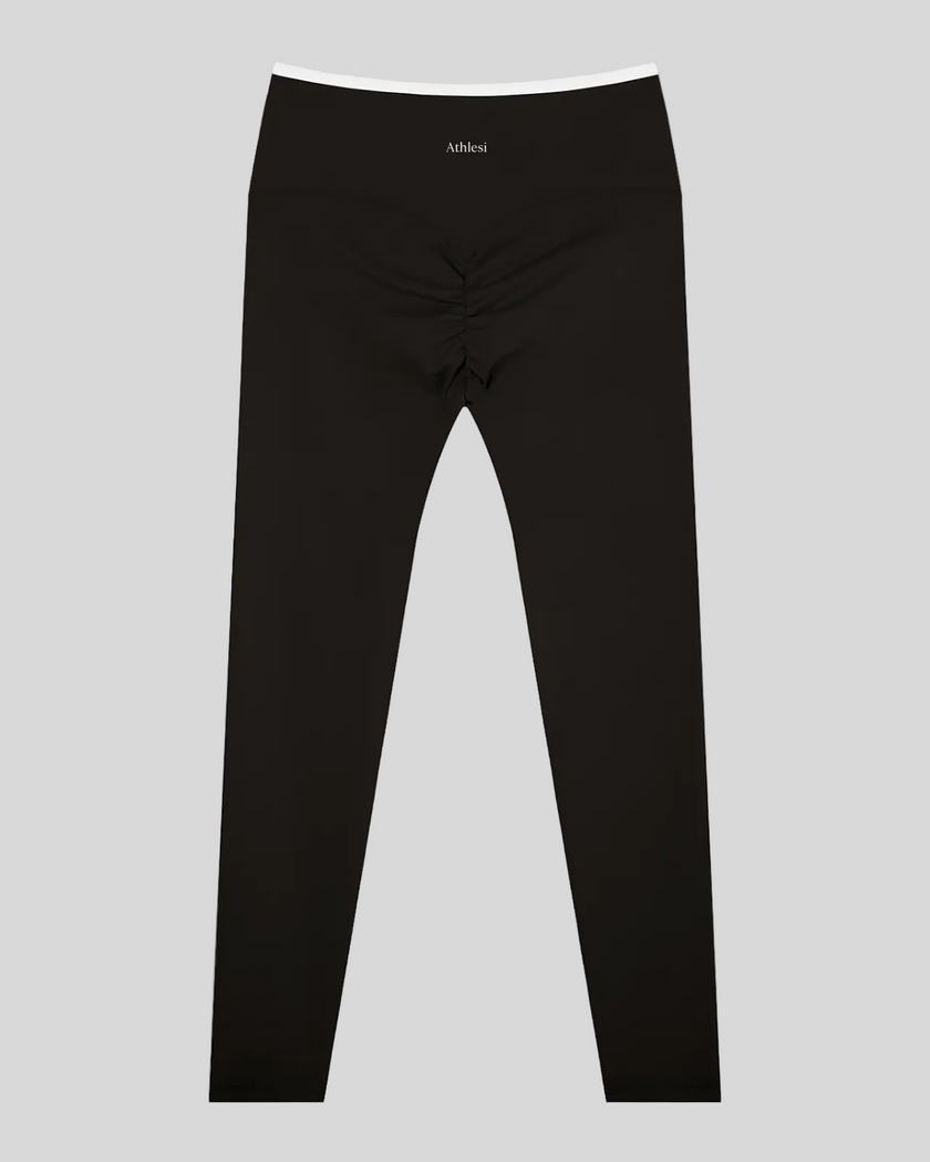 Back view of TrackLine Sculpt Leggings in black and white with contour shaping and ruched detail