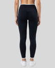 Back view of model wearing black TrackLine Sculpt Leggings featuring contour shaping detail