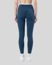 Back view of model wearing blue TrackLine Sculpt Leggings featuring contour shaping detail